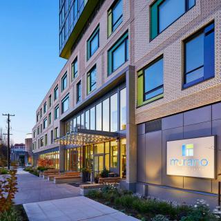 A modern hotel building with a welcoming entrance in an urban setting.