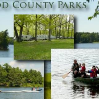 A scenic view of a county park featuring camping, boating, and lush greenery.