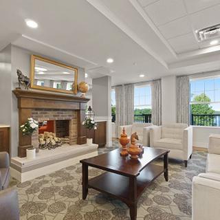 A stylish living room with a cozy fireplace, comfortable sofas, and a decorative coffee table.