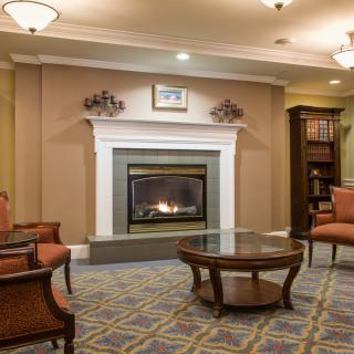 A cozy living room with a fireplace and comfortable seating.