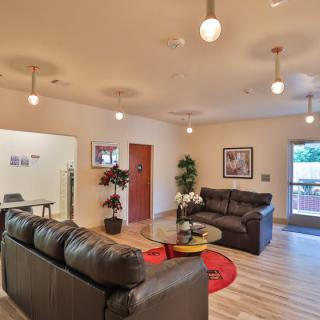 A modern living room featuring comfortable sofas, stylish decor, and ample natural light.