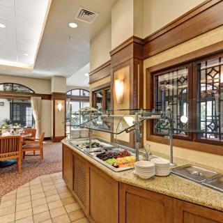 A restaurant buffet setup with a salad bar and elegant interior design.