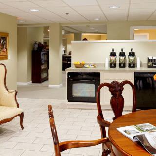 A cozy kitchen and dining area featuring classic furniture and a coffee station.