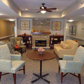 A cozy living room with comfortable seating and a fireplace.
