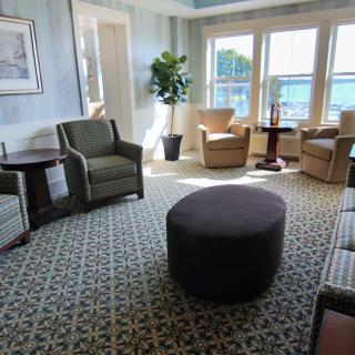 A cozy living room with comfortable seating, large windows, and natural lighting.