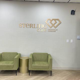 A modern waiting area featuring stylish green chairs and a branded wall in a healthcare setting.