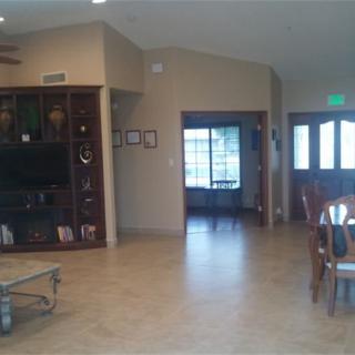 A spacious living room with a TV and dining area.