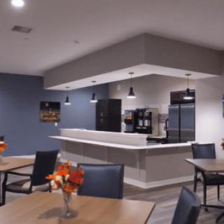 A modern kitchen and dining area with stylish furniture and appliances.