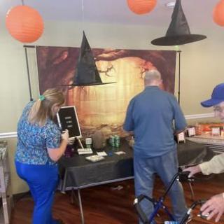 People enjoying a Halloween-themed party with decorations and costumes.