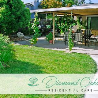 A peaceful residential garden patio with lush greenery and outdoor furniture.