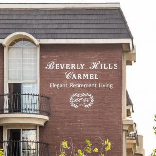 A view of the Beverly Hills Carmel building with elegant retirement living signage.