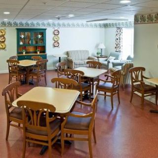 A cozy indoor dining area with multiple tables and chairs arranged for seating.