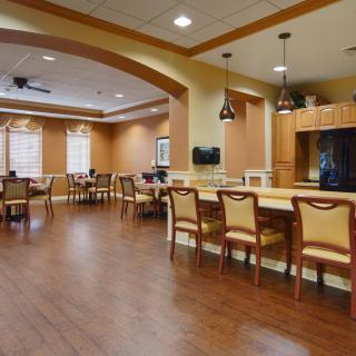 A cozy dining area with wooden flooring and elegant furniture.