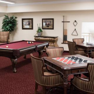 A cozy game room featuring a pool table and checkers set.