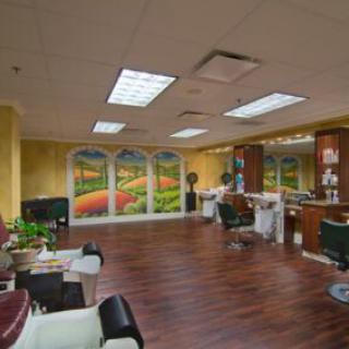 Interior of a salon with hair care stations, chairs, and decorative artwork on the walls.