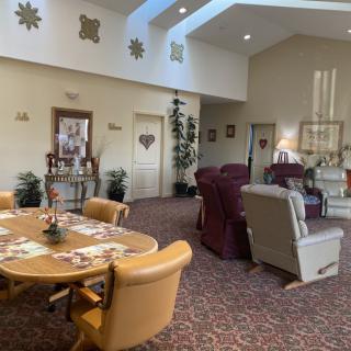 A cozy living room and dining area with comfortable seating and soft lighting.