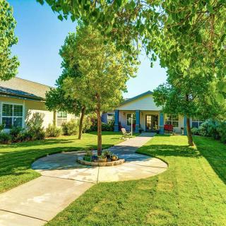 A charming house with a well-maintained garden and lush green surroundings.