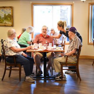 A group of seniors enjoying a meal together in a cozy restaurant setting.