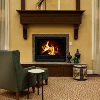 A cozy living room with a fireplace and comfortable seating.