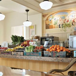 A grocery store counter displaying fresh fruits and vegetables.