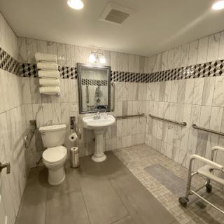 An accessible bathroom designed for ease of use with grab bars and a spacious layout.