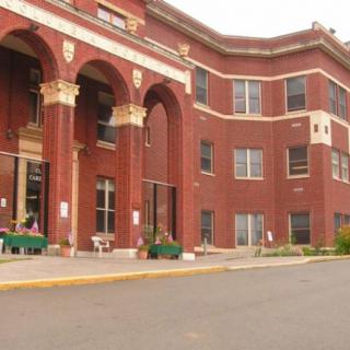 A historic brick building with arched windows and decorative columns.