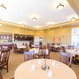Interior view of a spacious dining room with neatly arranged tables and chairs.
