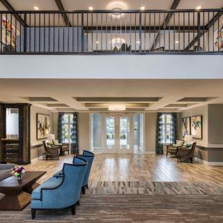 A modern and spacious lobby with elegant furniture and architectural design.