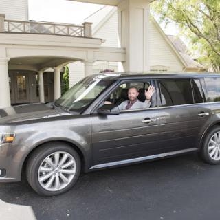 A joyful moment captured as two people enjoy a ride in their SUV.