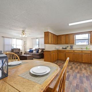 An open-concept kitchen and living area with wood cabinets and flooring.