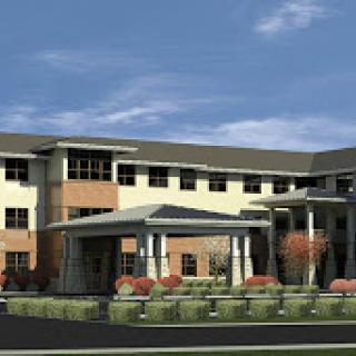 A modern commercial building featuring a welcoming entrance and landscaped surroundings.