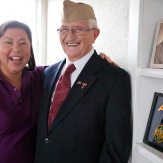 A joyful moment between a veteran and a friend, celebrating their bond.