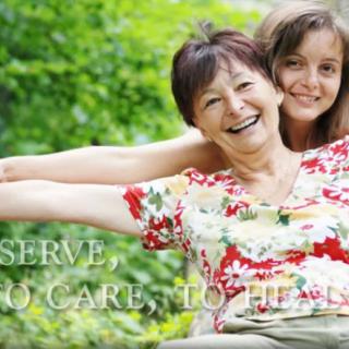 Two women smiling and enjoying time together outdoors.