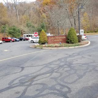 A view of a parking area surrounded by trees with autumn colors.