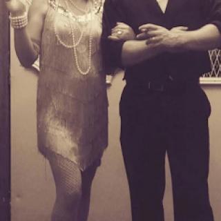 A stylish couple dressed in 1920s attire, ready for a night of dancing.