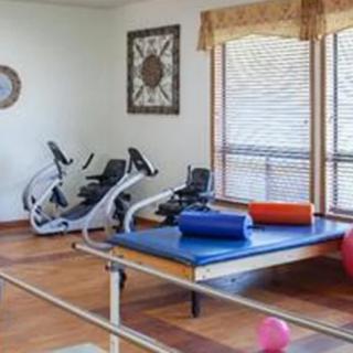 A room with exercise bikes and a mat for fitness activities.