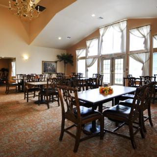 Spacious dining area with large windows and elegant furnishings.