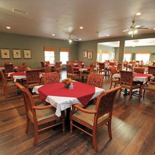 An empty restaurant dining area with neatly arranged tables and chairs.