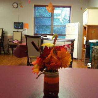 A cozy indoor setting with a vibrant autumn flower arrangement on the table.