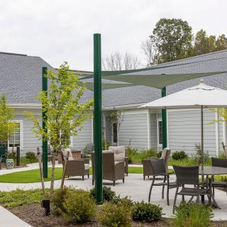 Outdoor patio area with furniture and garden landscaping.