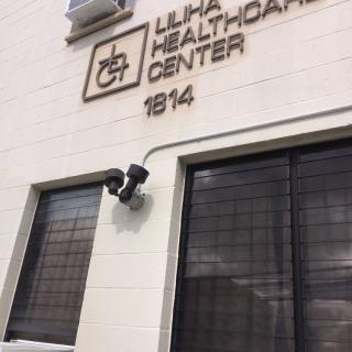 Exterior view of the Liliha Healthcare Center with visible security cameras.
