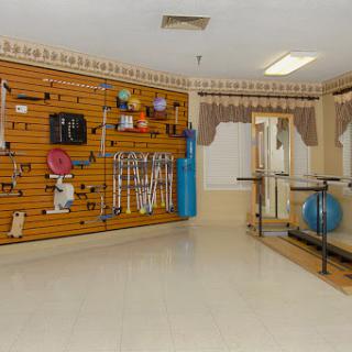 A well-equipped rehabilitation space featuring various therapy tools and exercise equipment.