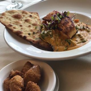 A delicious plate of pasta served with bread, accompanied by a side dish.