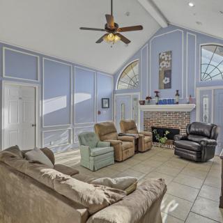 A spacious living room with comfortable seating and a fireplace.