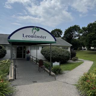 A welcoming view of the Leominster building, surrounded by well-maintained greenery and a clear sky.