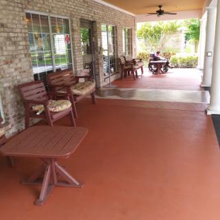 A cozy porch area with wooden furniture, perfect for relaxation.