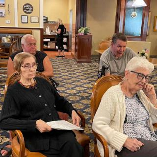 A group of adults engaged in conversation during a social event.