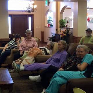 A group of seniors enjoying leisure time together in a cozy seating area.