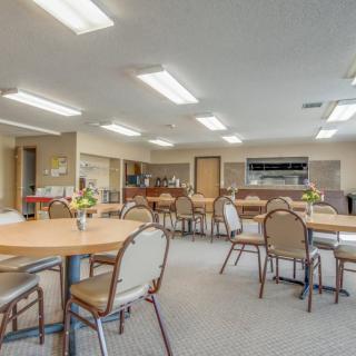 A spacious dining area with multiple tables and chairs, suitable for community gatherings.