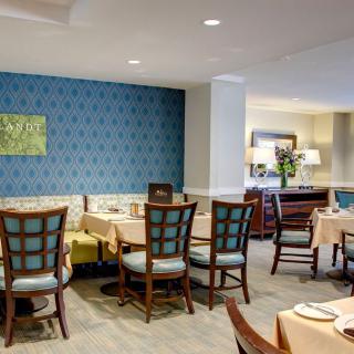 A cozy restaurant dining area with neatly arranged tables and chairs, featuring elegant interior design.